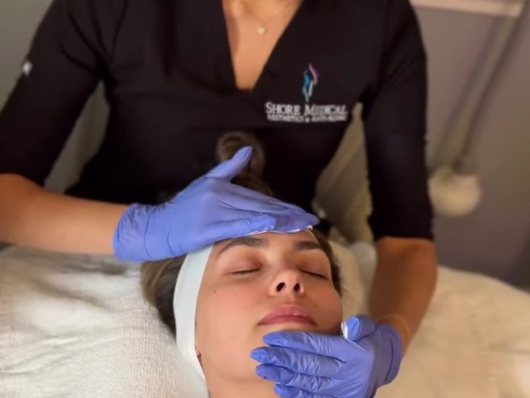 Medical aesthetician performing a facial treatment at Bellmore Med Spa